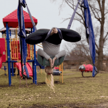 yoga trapeze swing in playground by woman