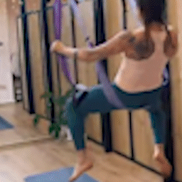 Yoga trapeze swing used in studio by swinging woman