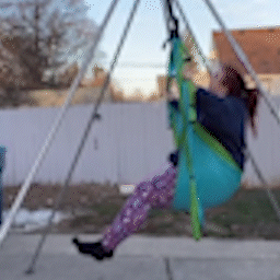 Yoga trapeze swing being used with Yoga trapeze stand outdoors