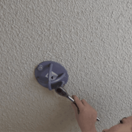 Yoga trapeze swing set up with Ceiling hooks by woman